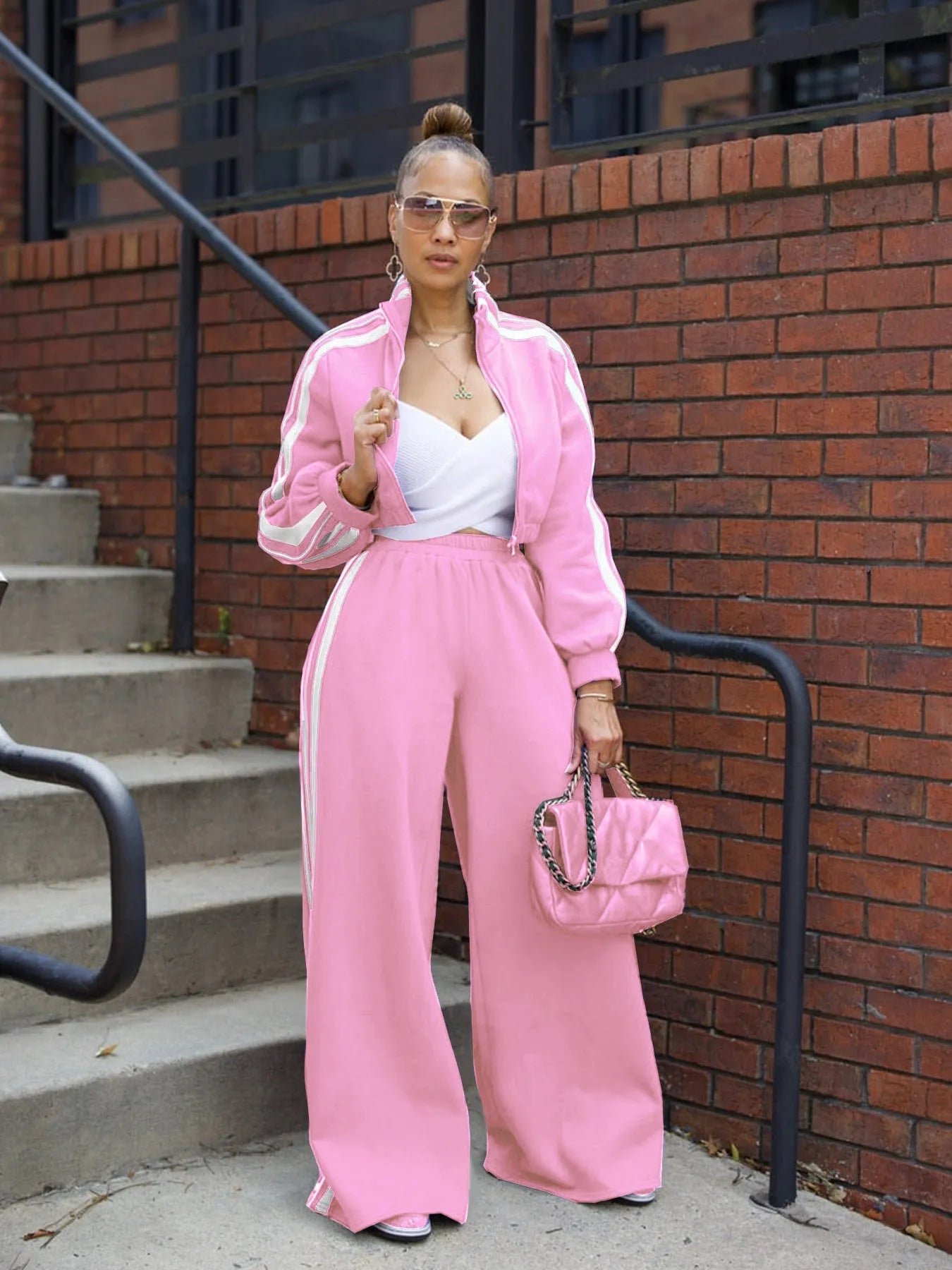 Grey striped streetwear two-piece set featuring a sweater with regular sleeves and matching trousers.