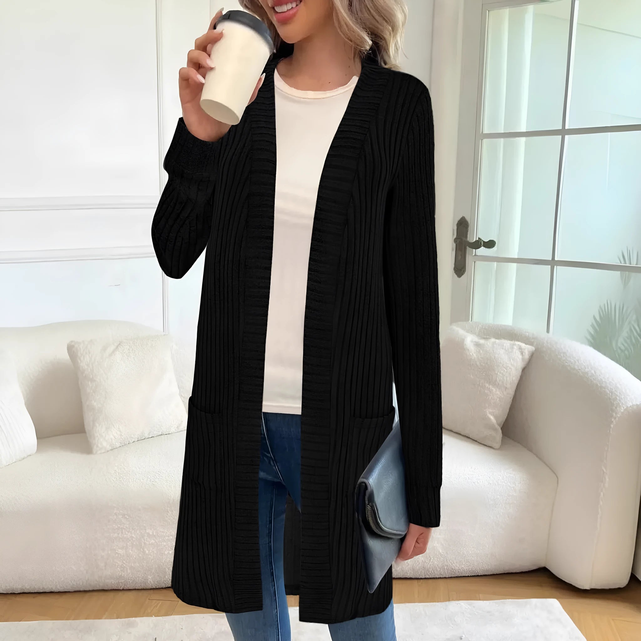Long sleeve loose fit knitted cardigan jacket in black, shown with two front pockets.