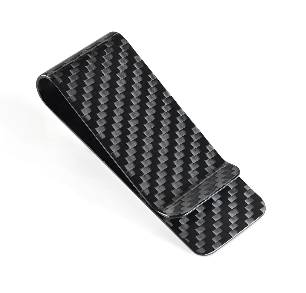 Glossy black carbon fibre money clip with striped pattern on white background