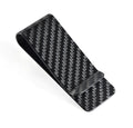 Glossy black carbon fibre money clip with striped pattern on white background
