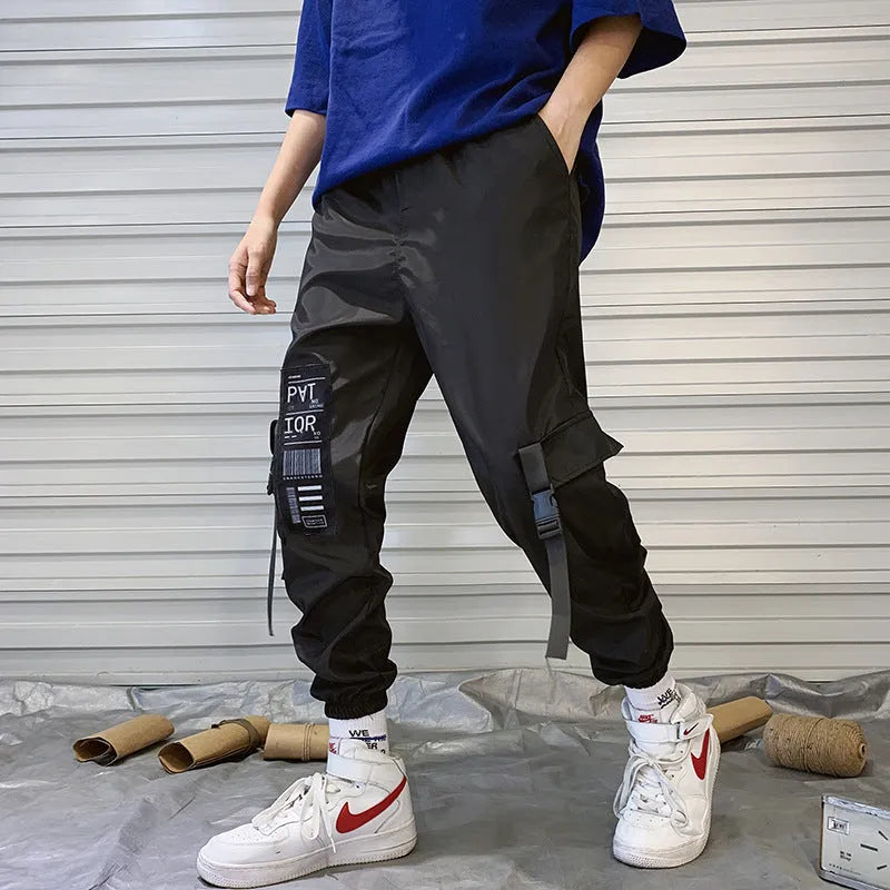 Men's hiphop trousers in black acetate fibre with tapered leg, side view