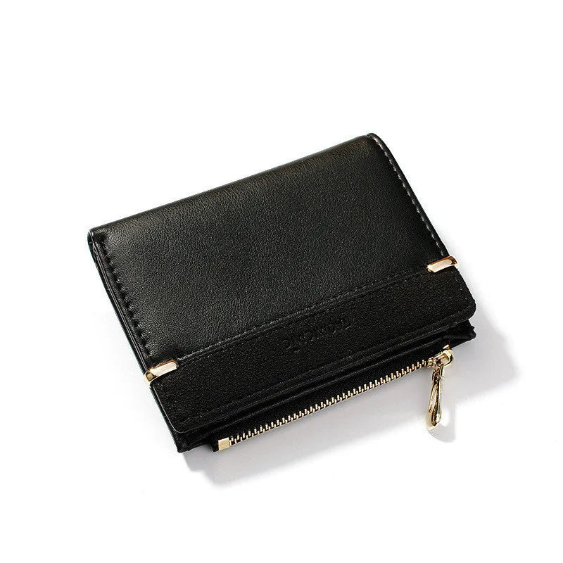 Black ladies folding wallet with a short zip, open to show multiple card slots, bill holder, and change compartment.