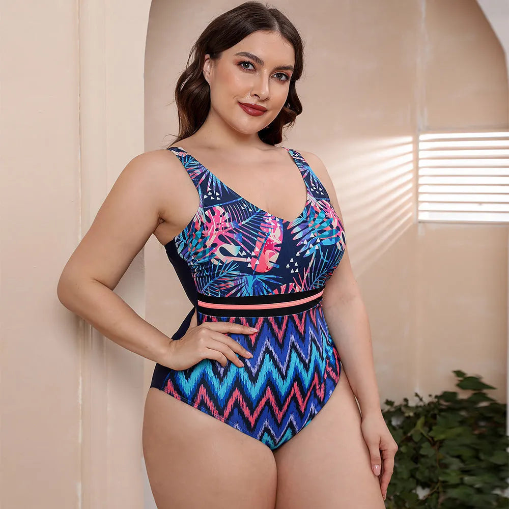 Blue and white printed one-piece swimsuit for women with spaghetti straps, shown on a mannequin.