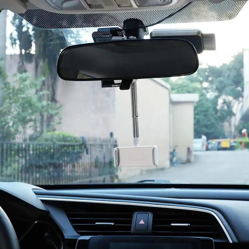 Black ABS plastic mobile phone bracket mounted on a car rearview mirror stem.