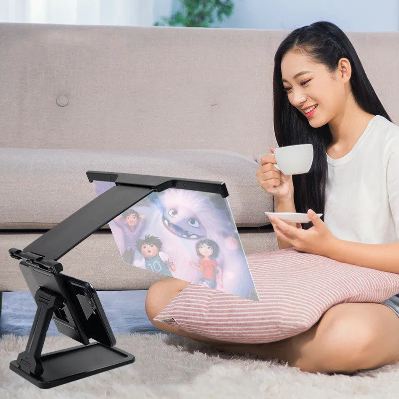 Black L20 split mobile phone screen magnifier with mounting bracket on a table