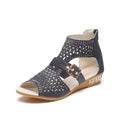 Women's beige flat sandals with rivet details, fish mouth toe, back zipper, and wedge heel