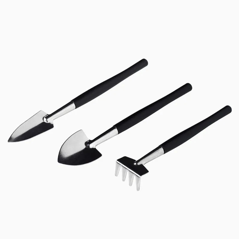 Black plastic and metal 16-piece mini garden hand tool set for succulents and bonsai, displayed with cushion.