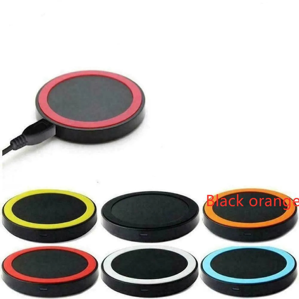 Square Qi wireless phone charging pad in multiple colours on a wooden surface.