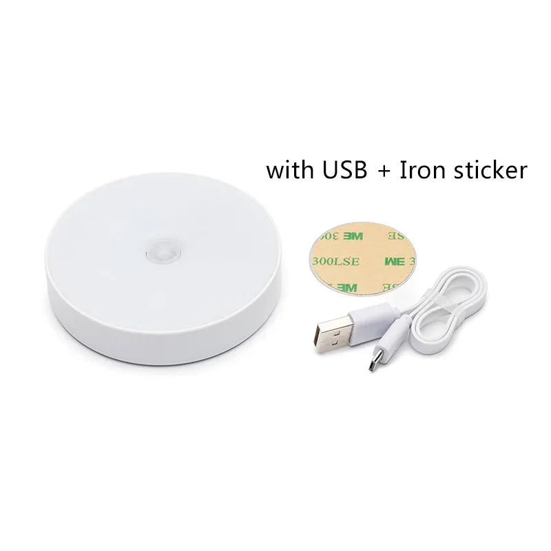 Compact round white LED motion sensor night light with USB charging cable and adhesive tape