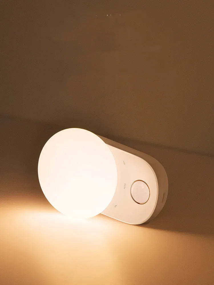 White rechargeable bedside night light with motion sensor and USB charging port