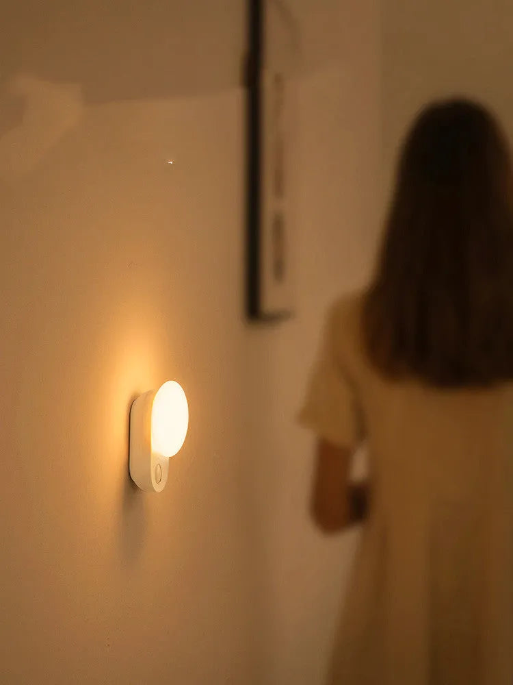 White rechargeable bedside night light with motion sensor and USB charging port