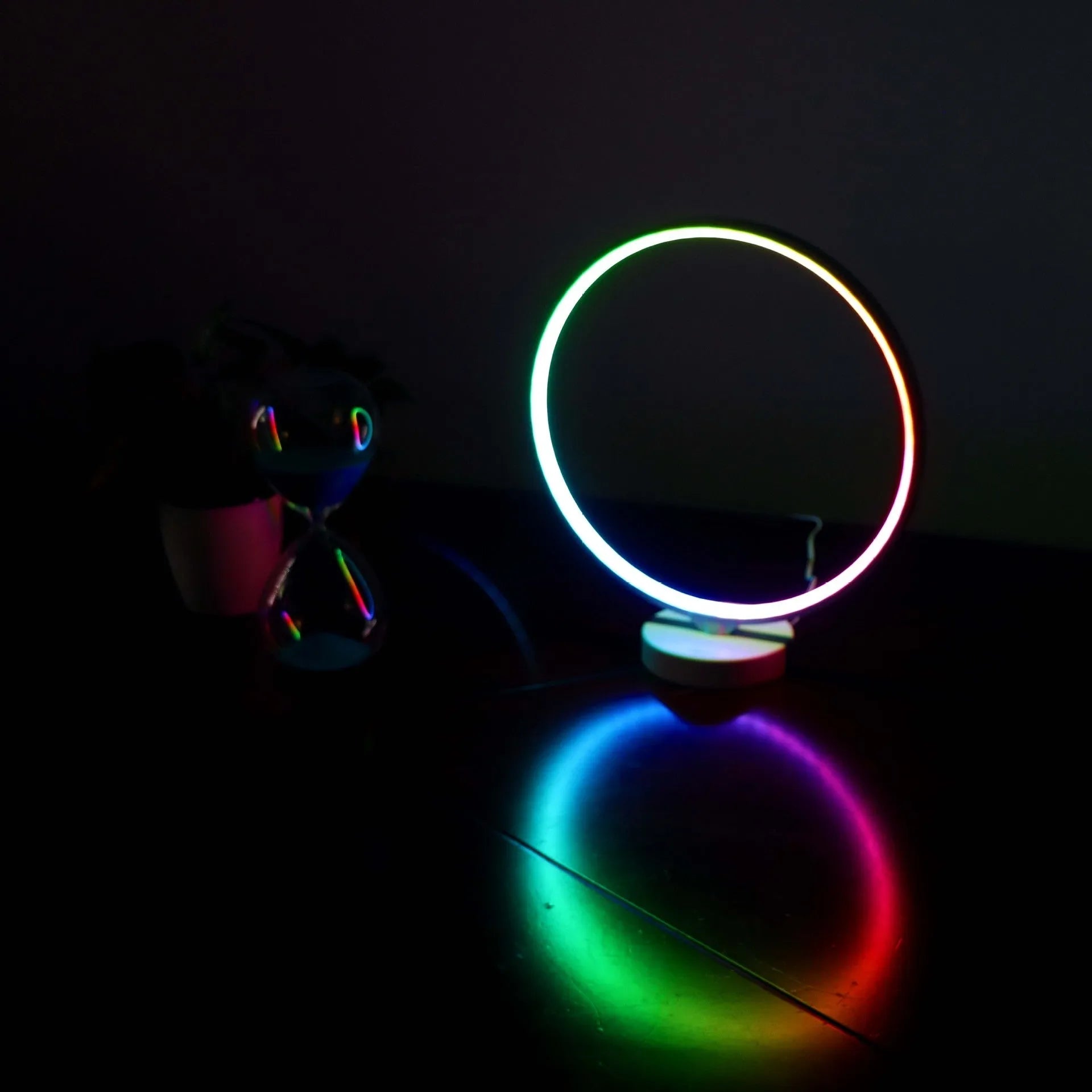 White Full Moon Table Lamp with remote control on a wooden surface, showing its spherical silicone and aluminium design.