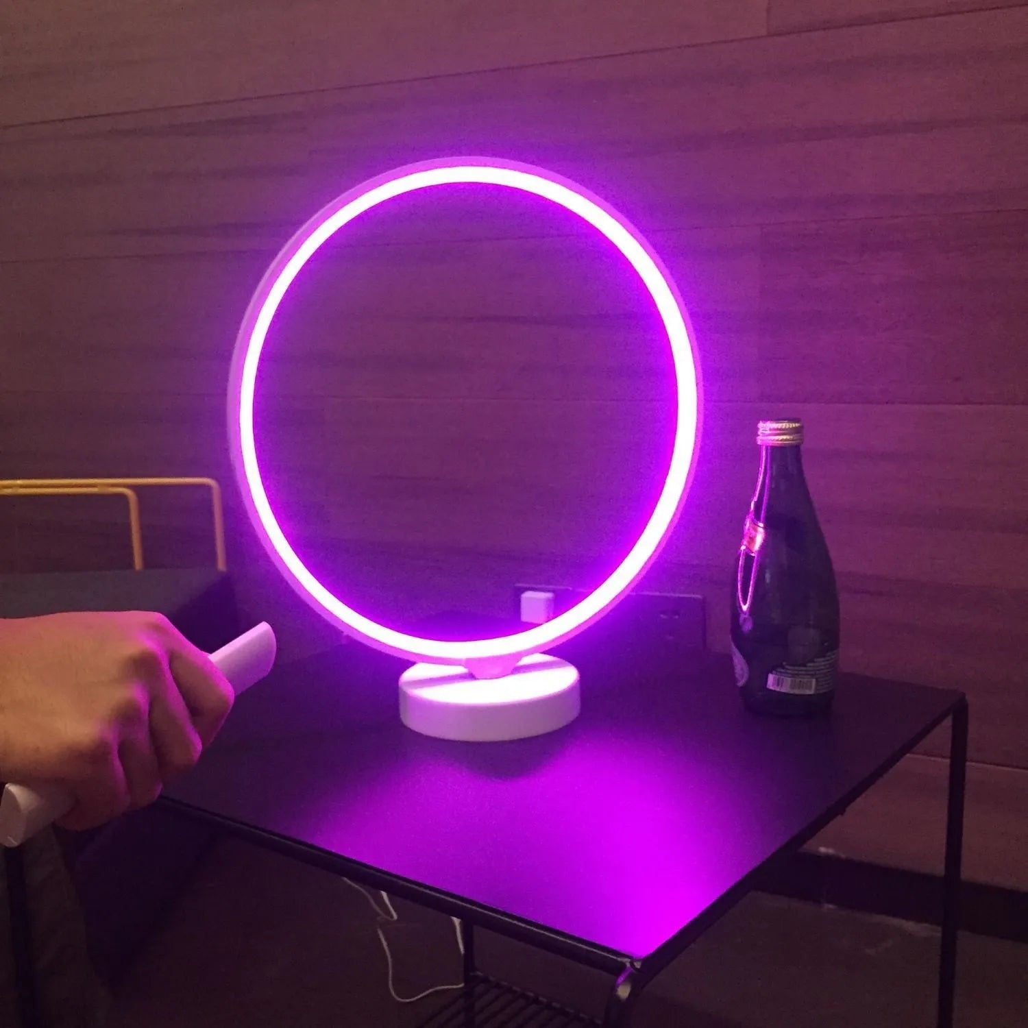 White Full Moon Table Lamp with remote control on a wooden surface, showing its spherical silicone and aluminium design.