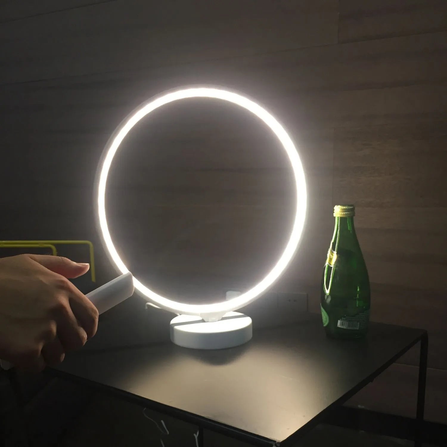 White Full Moon Table Lamp with remote control on a wooden surface, showing its spherical silicone and aluminium design.