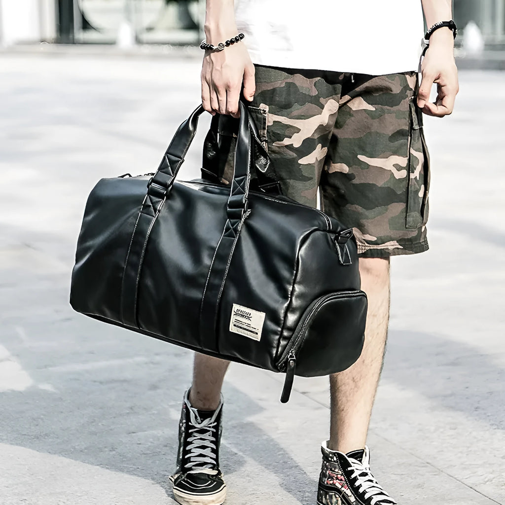 Large black PU leather sports training bag showing multiple internal compartments including a laptop sleeve.