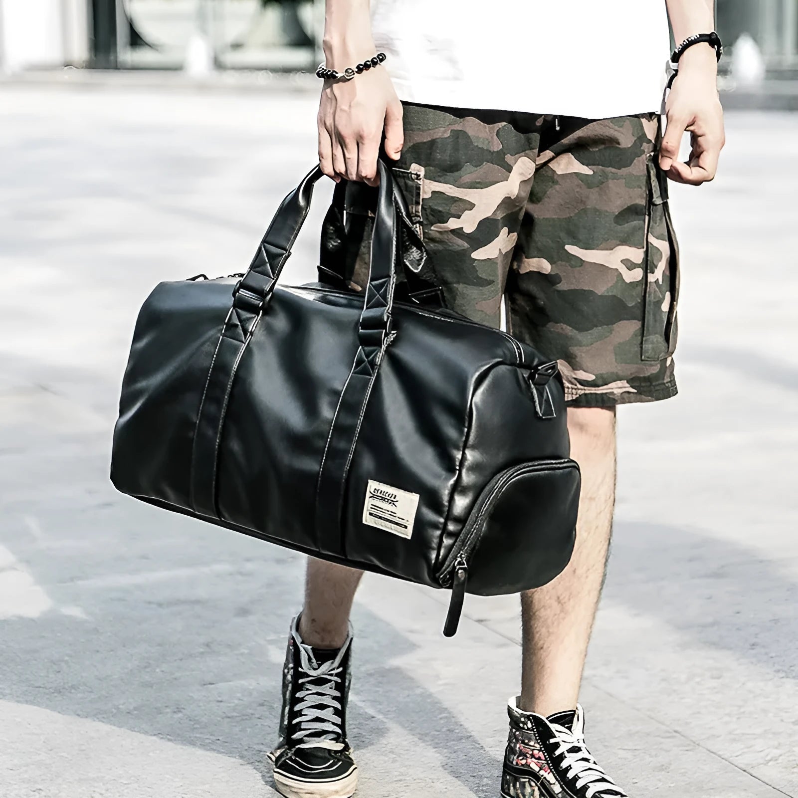 Large black PU leather sports training bag showing multiple internal compartments including a laptop sleeve.