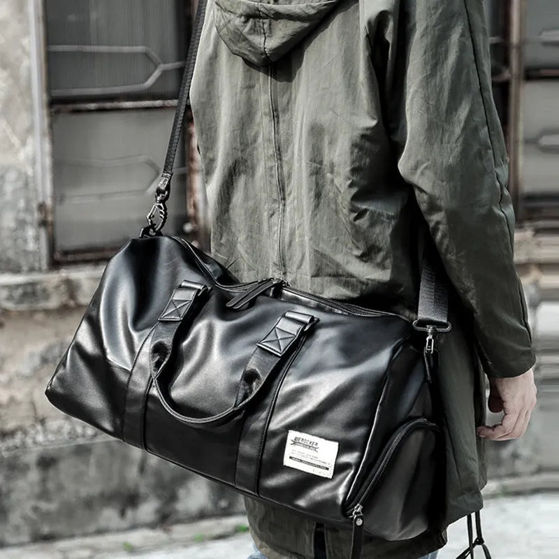 Large black PU leather sports training bag showing multiple internal compartments including a laptop sleeve.