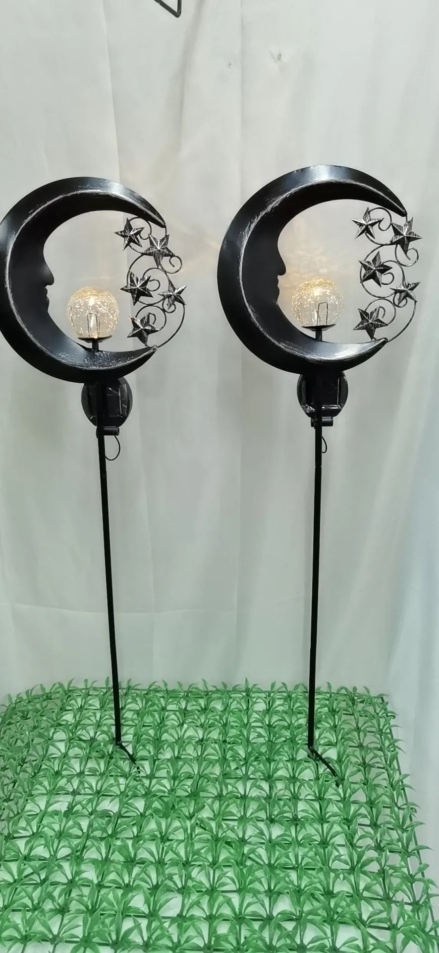 Blue moon-shaped solar garden light with wrought iron metal frame and crack glass ball.