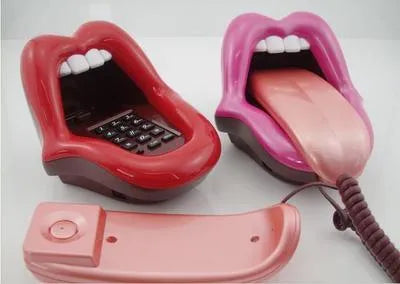 Red lip novelty telephone with LED indicator on a desk