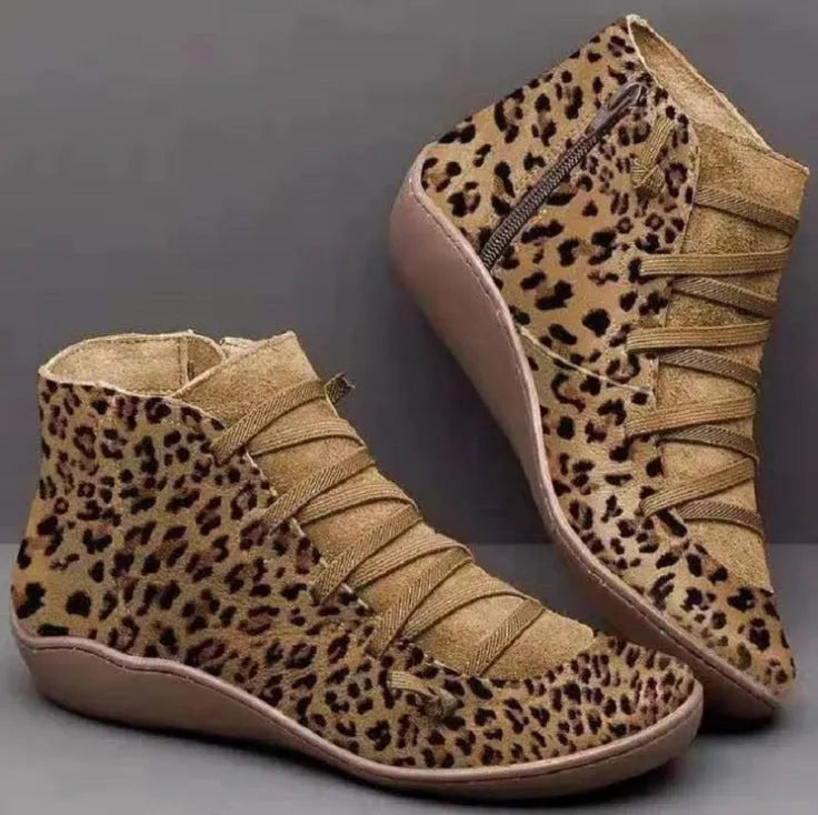 Women's flat wedge heel ankle booties in various colours including leopard print, with round toe and rubber sole.