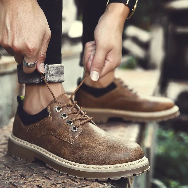 Men's black casual shoes with round toe and front-tie lacing on a rubber sole