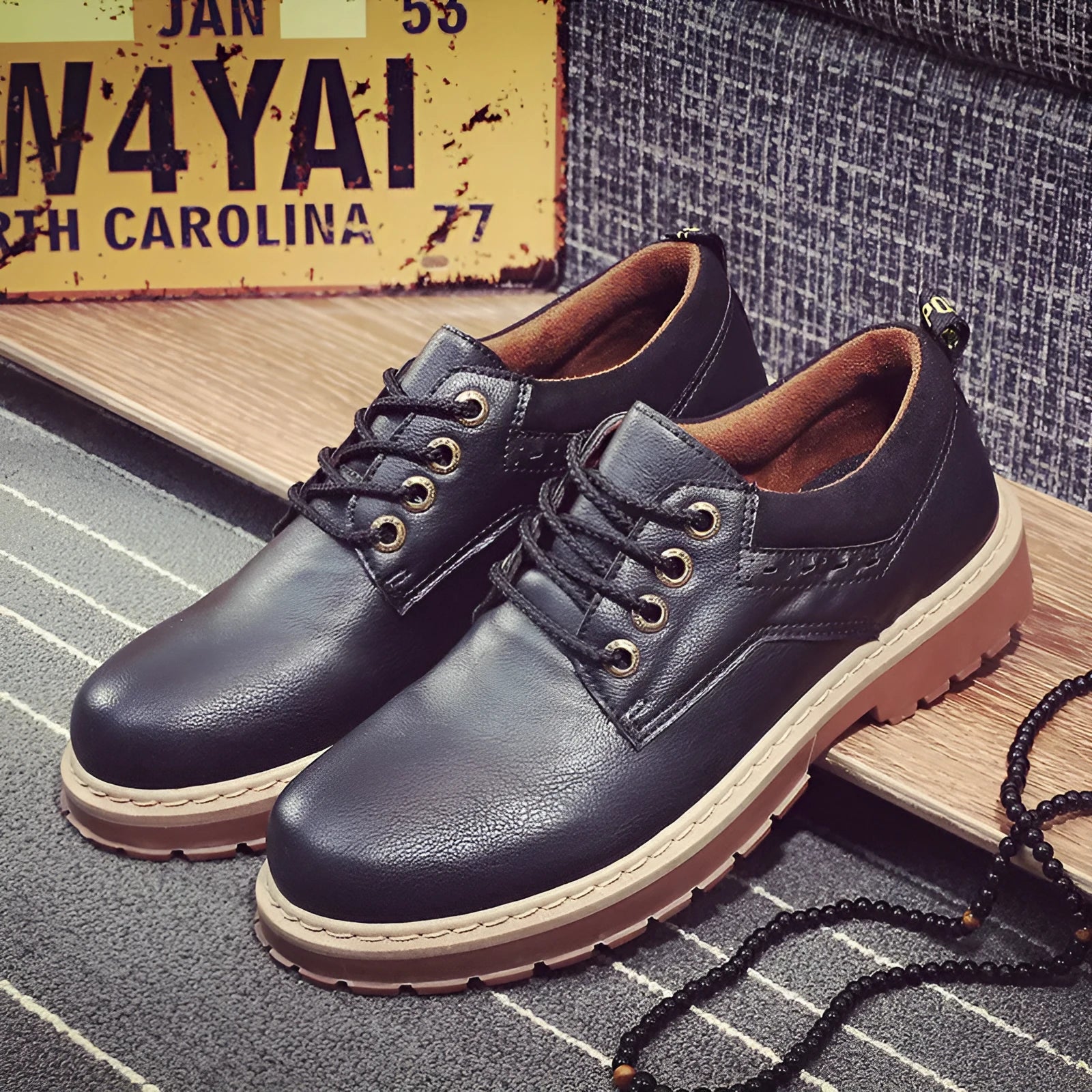 Men's black casual shoes with round toe and front-tie lacing on a rubber sole