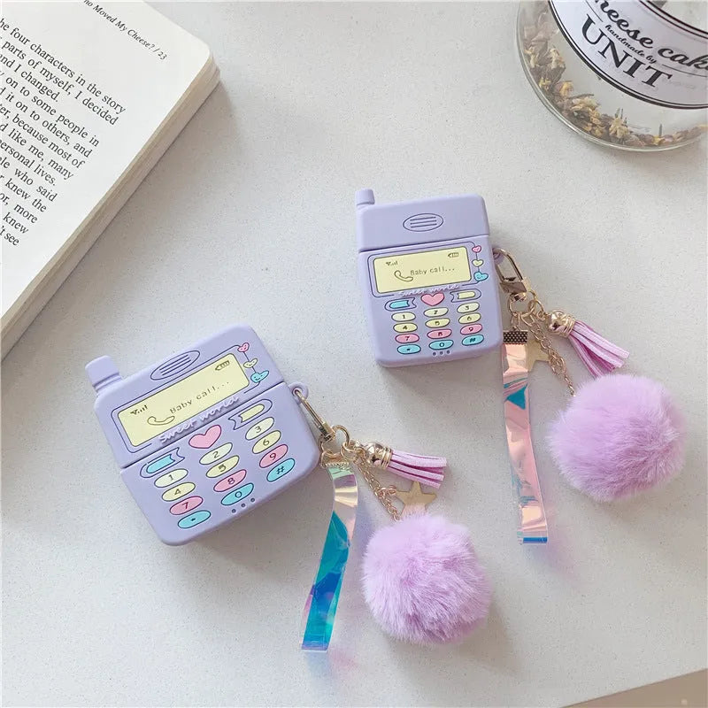 Purple silicone Apple AirPods case with clamshell design and attached fur ball pendant