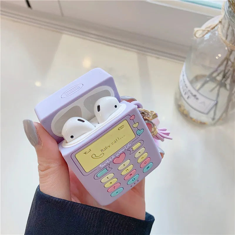 Purple silicone Apple AirPods case with clamshell design and attached fur ball pendant