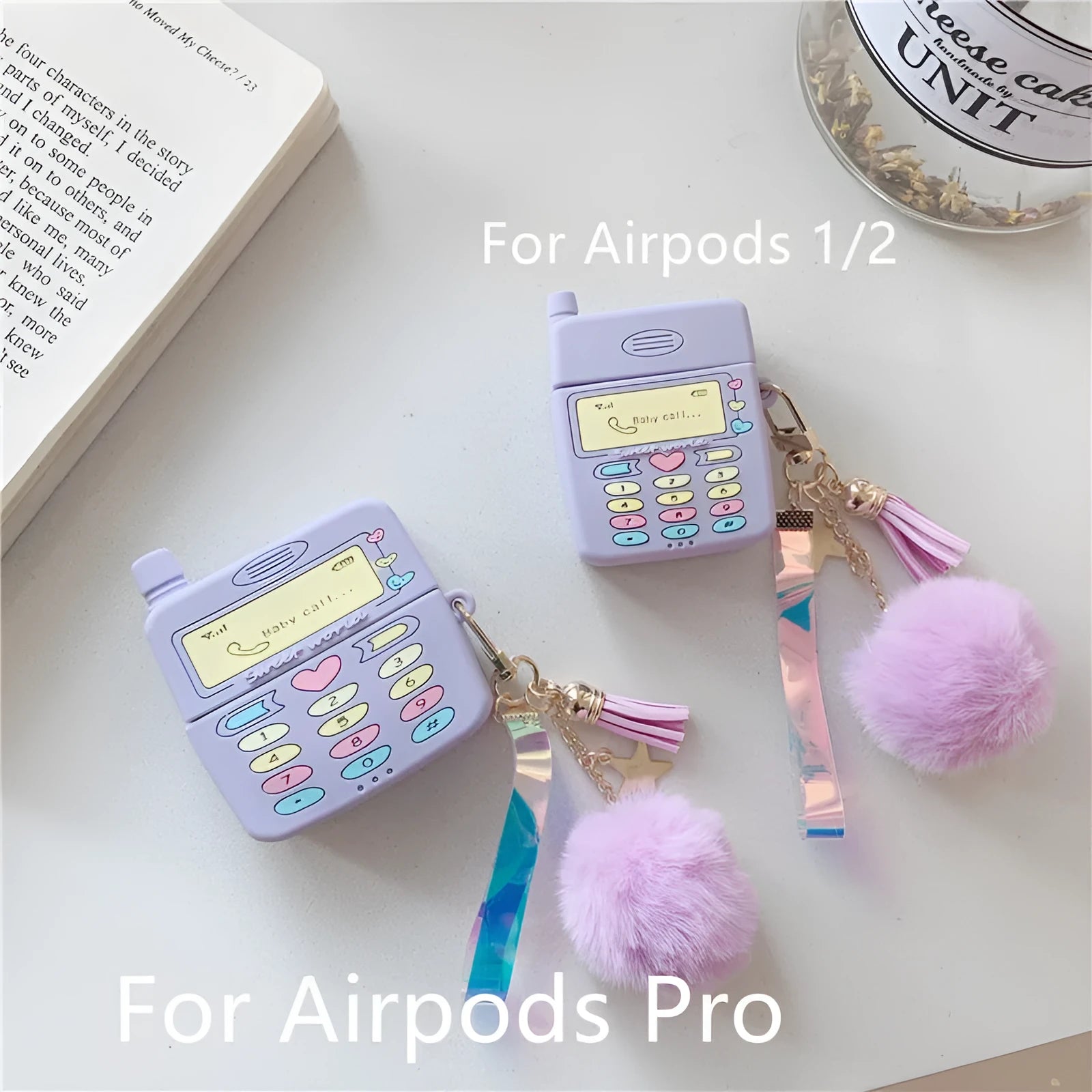 Purple silicone Apple AirPods case with clamshell design and attached fur ball pendant