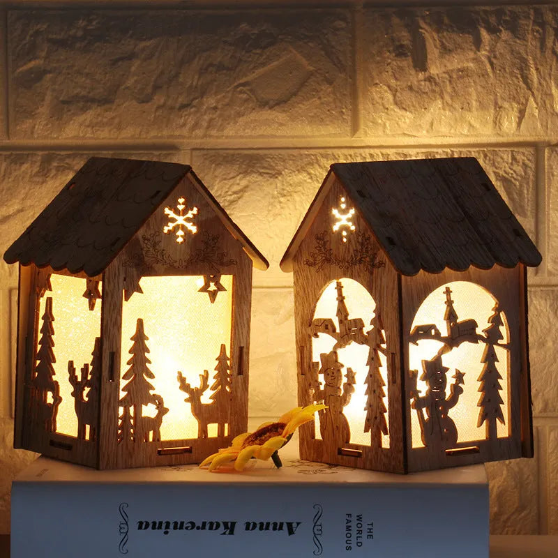 Three wooden Christmas decorations: small log bell and two wooden houses with Father Christmas and snowman designs