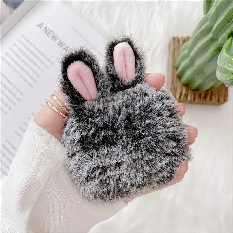 Pink plush silicone AirPods cover with rabbit ears protecting wireless earbuds case