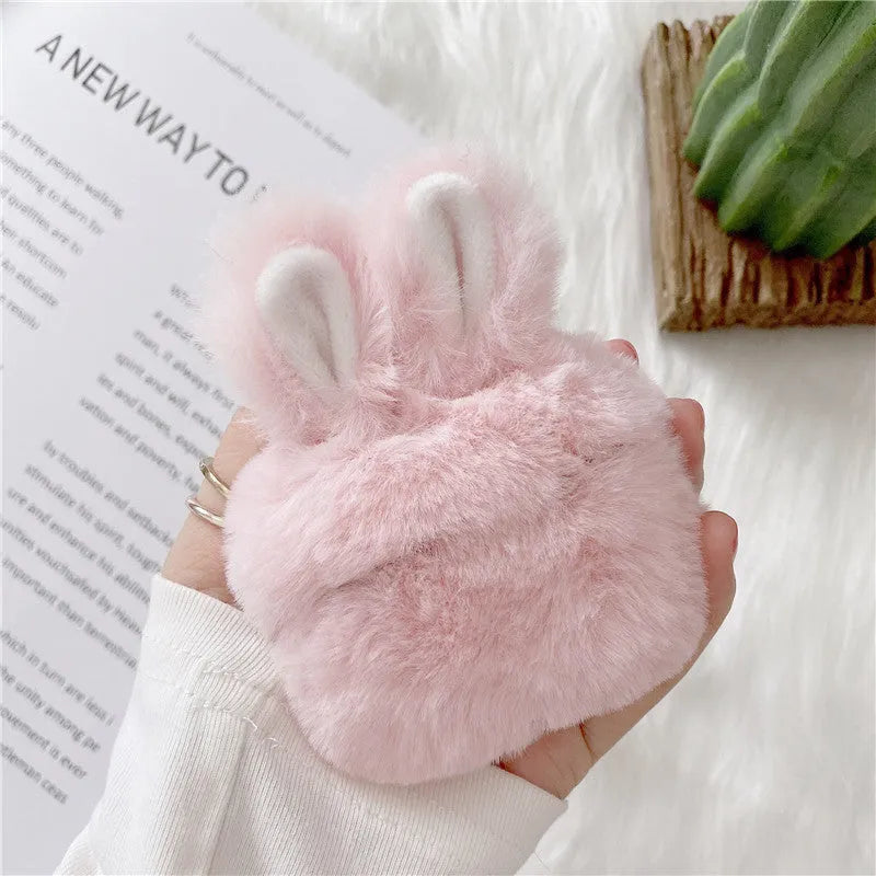 Pink plush silicone AirPods cover with rabbit ears protecting wireless earbuds case