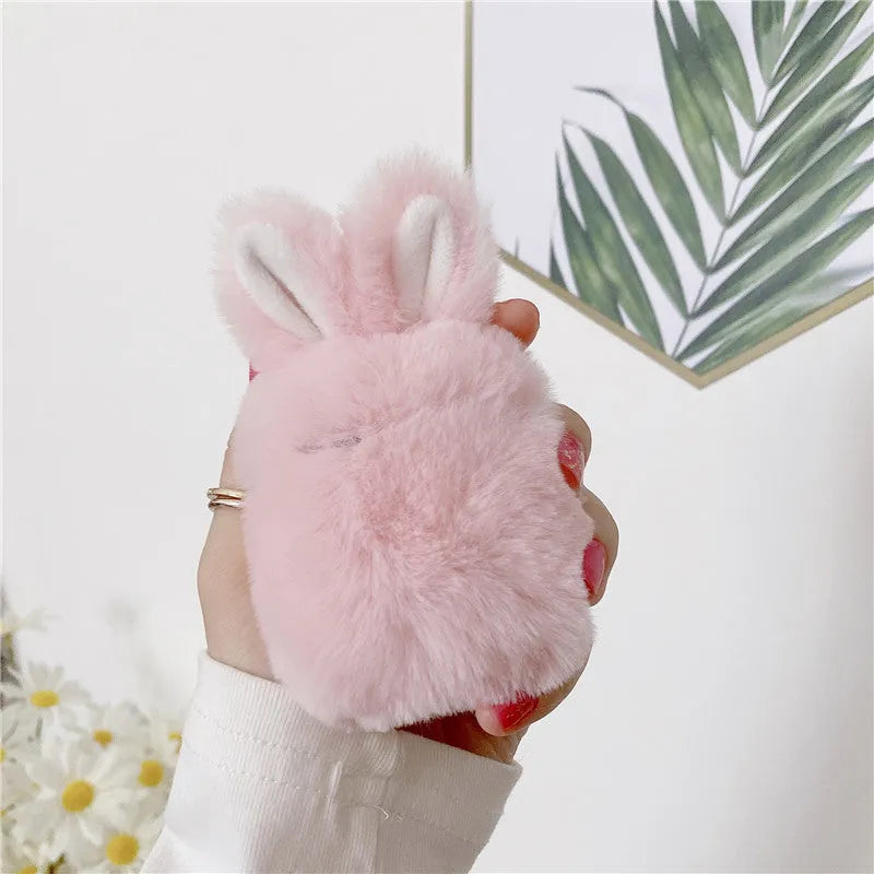 Pink plush silicone AirPods cover with rabbit ears protecting wireless earbuds case