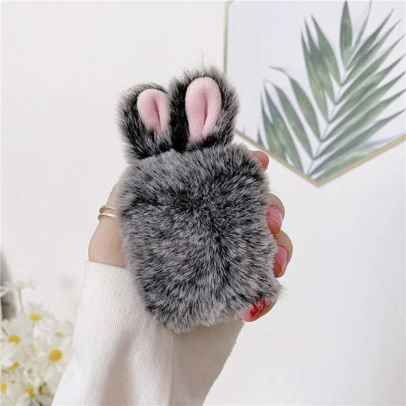 Pink plush silicone AirPods cover with rabbit ears protecting wireless earbuds case