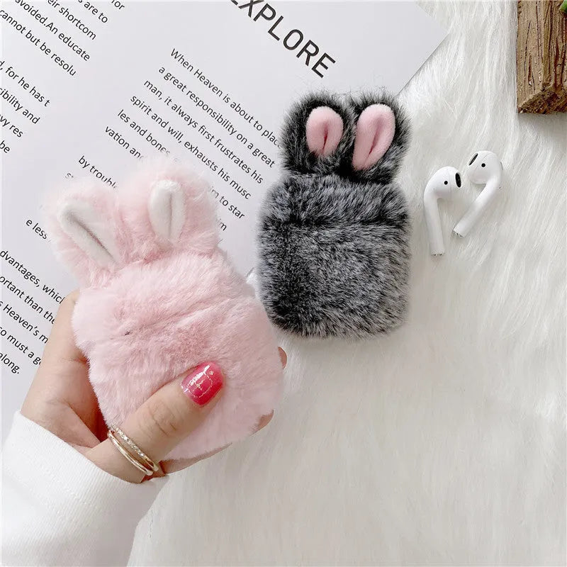 Pink plush silicone AirPods cover with rabbit ears protecting wireless earbuds case