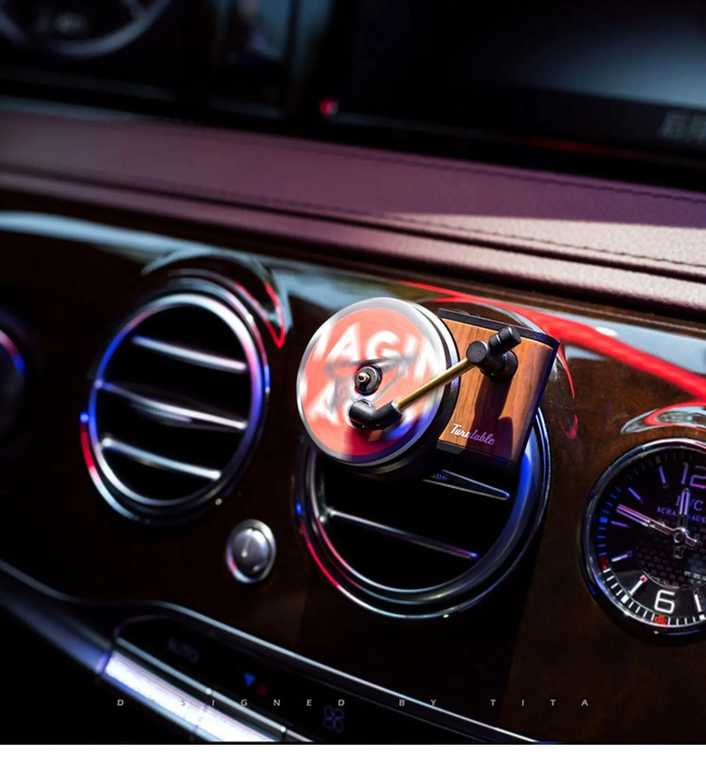 Brown alloy car perfume clip with record locomotive design on car air vent