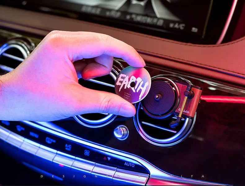 Brown alloy car perfume clip with record locomotive design on car air vent
