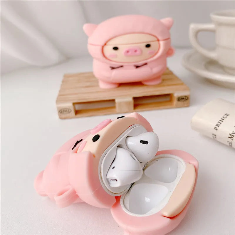 Pink silicone flip cover case for AirPods with a cartoon pig design and a metal keychain hook.