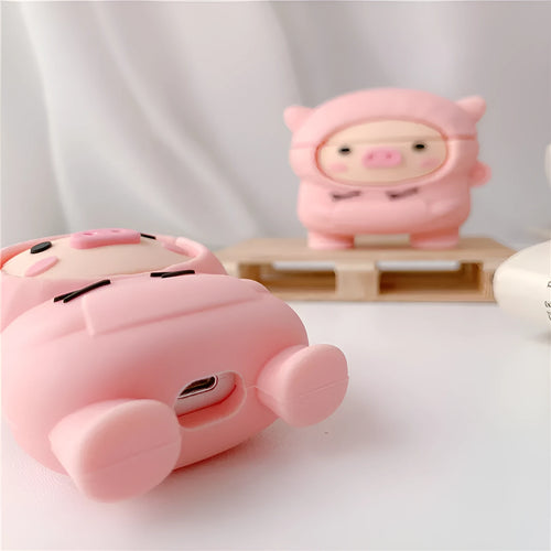 Pink silicone flip cover case for AirPods with a cartoon pig design and a metal keychain hook.