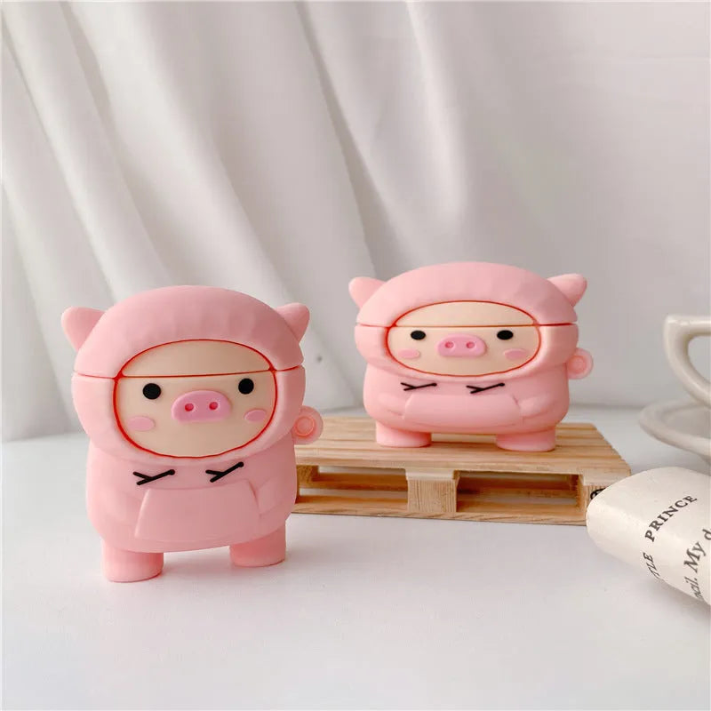 Pink silicone flip cover case for AirPods with a cartoon pig design and a metal keychain hook.