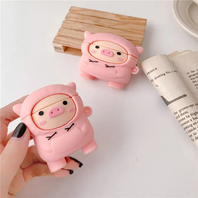 Pink silicone flip cover case for AirPods with a cartoon pig design and a metal keychain hook.