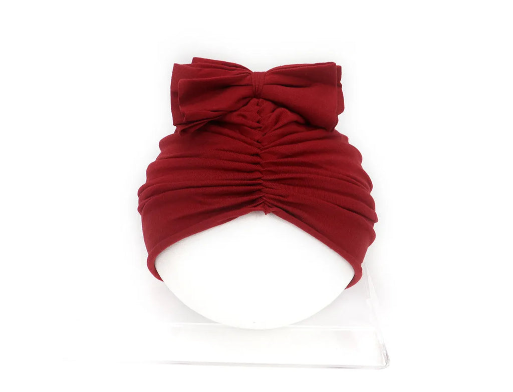 Soft acrylic knitted baby girl turban hat in a solid colour, suitable for newborns to 28 months.