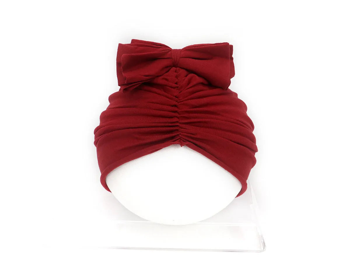 Soft acrylic knitted baby girl turban hat in a solid colour, suitable for newborns to 28 months.