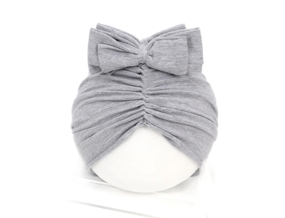Soft acrylic knitted baby girl turban hat in a solid colour, suitable for newborns to 28 months.