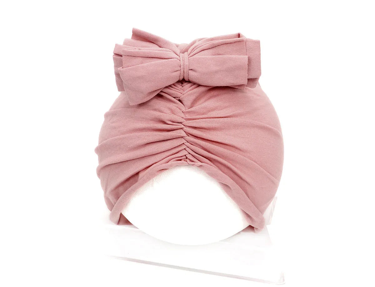 Soft acrylic knitted baby girl turban hat in a solid colour, suitable for newborns to 28 months.