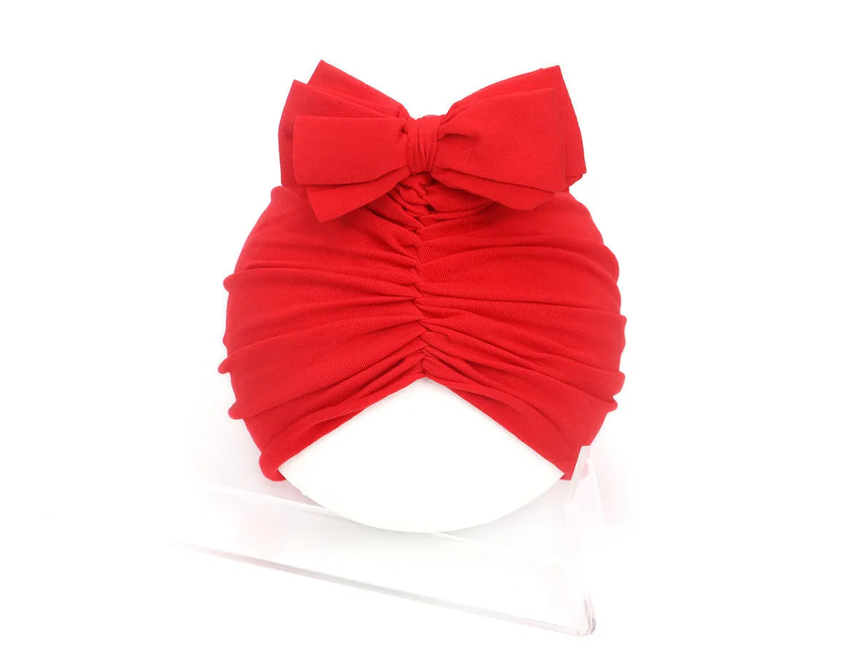 Soft acrylic knitted baby girl turban hat in a solid colour, suitable for newborns to 28 months.