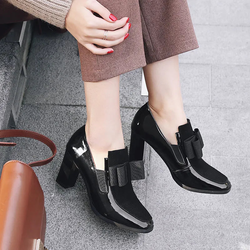 Black patent leather women's high heels with a thick square heel over 8cm high and a square toe.