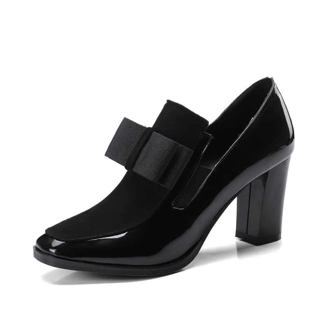 Black patent leather women's high heels with a thick square heel over 8cm high and a square toe.
