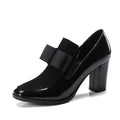 Black patent leather women's high heels with a thick square heel over 8cm high and a square toe.
