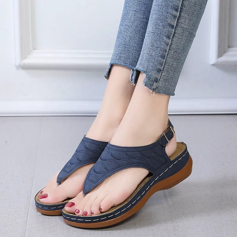 Women's casual wedge heel flip flop sandals with an adjustable back strap in solid colours.